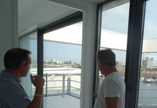 Inspectors with the buyer at the windows of a new apartment