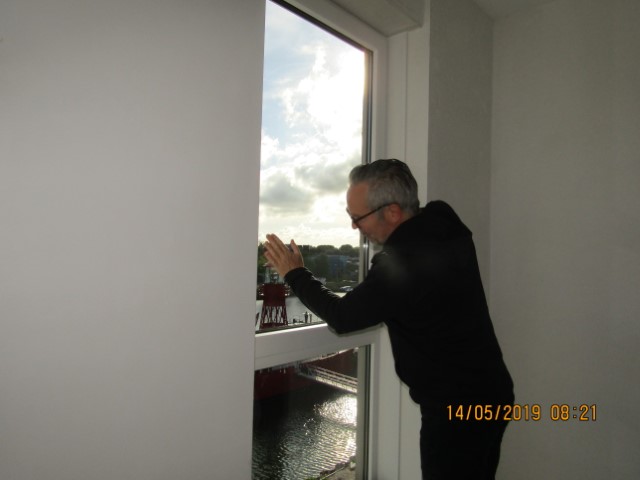 Inspector checking how a window opens and closes