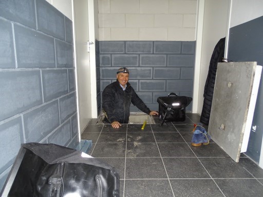 Inspector checking the floor tiles in a new apartment