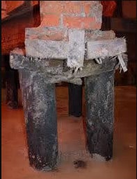 Timber piles under the floor Old timber foundation piles and beams under a floor