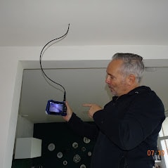 Inspector looking at the screen of an endoscope camera